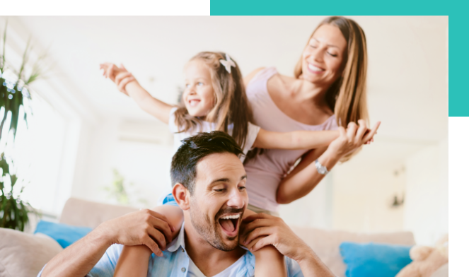 family smiles daughter on dads shoulders and mother holding her daughter hands
